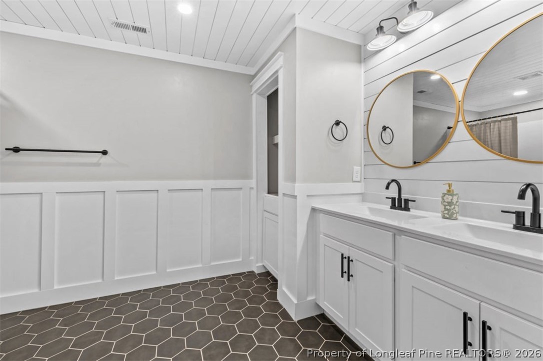 83 Kotata Avenue Bunnlevel, NC 28323 - Photo 37 of 49 a bathroom with a double vanity sink and a mirror
