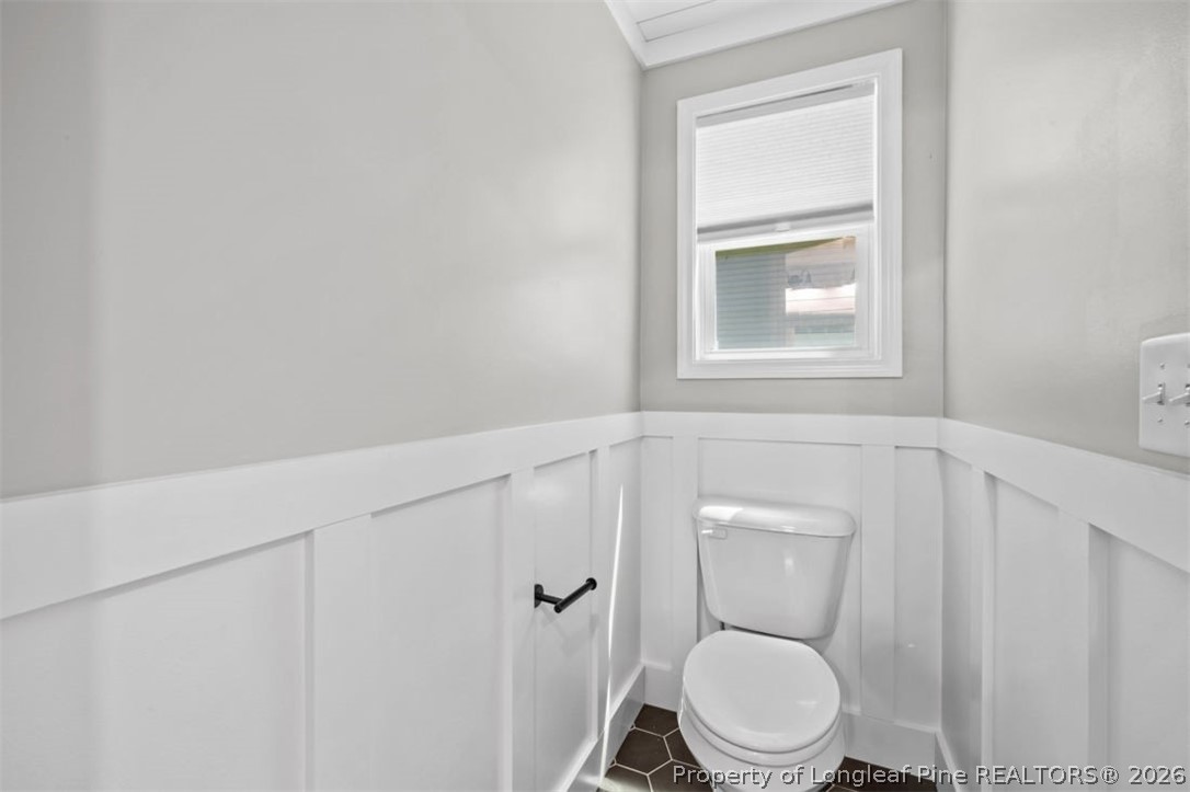 83 Kotata Avenue Bunnlevel, NC 28323 - Photo 38 of 49 a white toilet sitting next to a bathroom sink