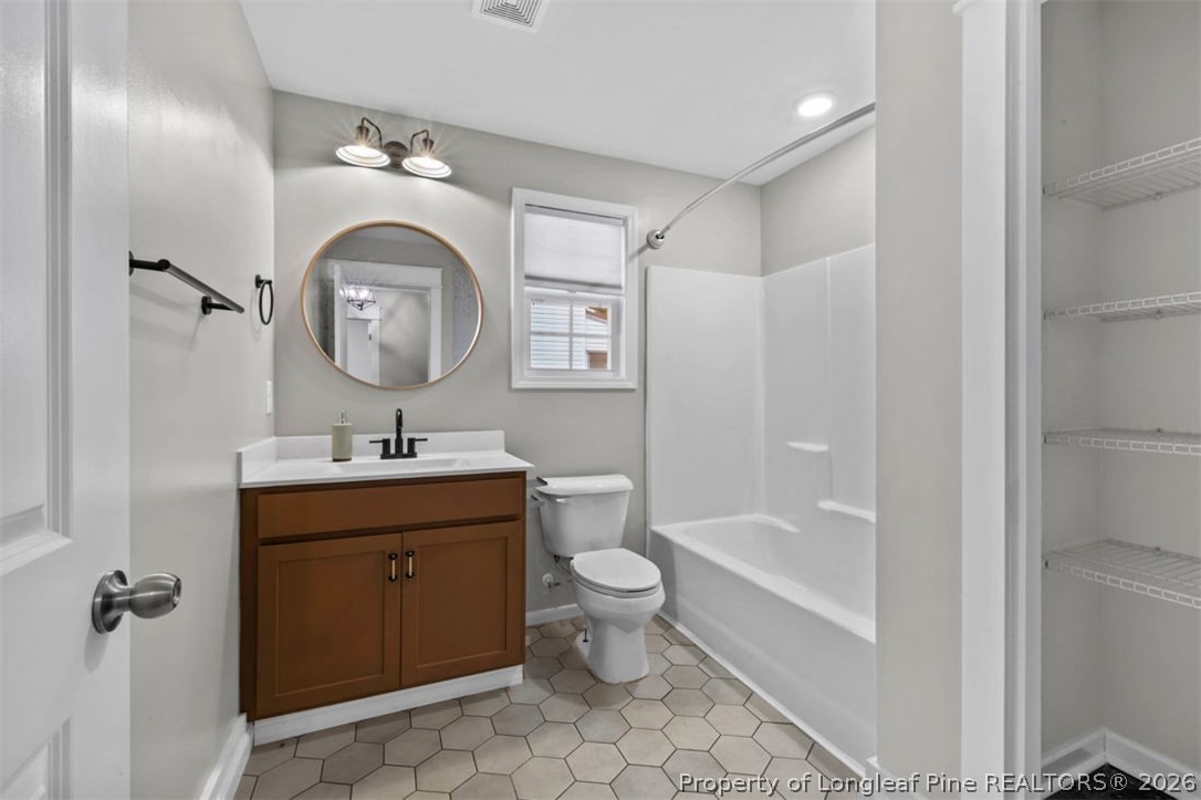 83 Kotata Avenue Bunnlevel, NC 28323 - Photo 41 of 49 a bathroom with a toilet sink and mirror