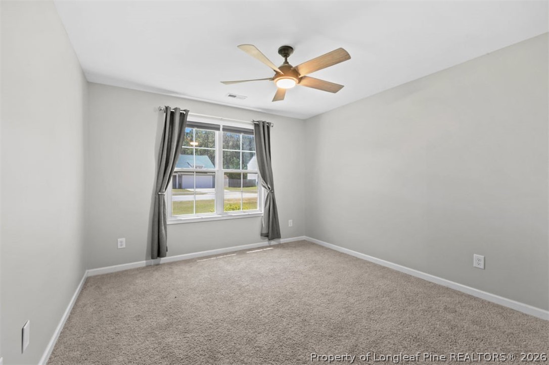 83 Kotata Avenue Bunnlevel, NC 28323 - Photo 42 of 49 an empty room with window and ceiling fan