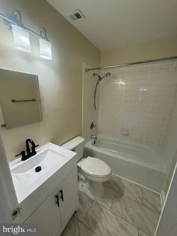 a bathroom with a sink mirror bathtub and toilet