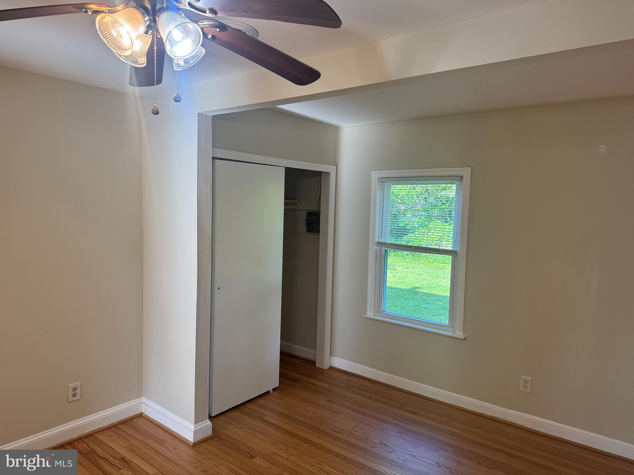 2810 Xavier Lane District Heights, MD 20747 - Photo 18 of 27 a view of an empty room with wooden floor and a window
