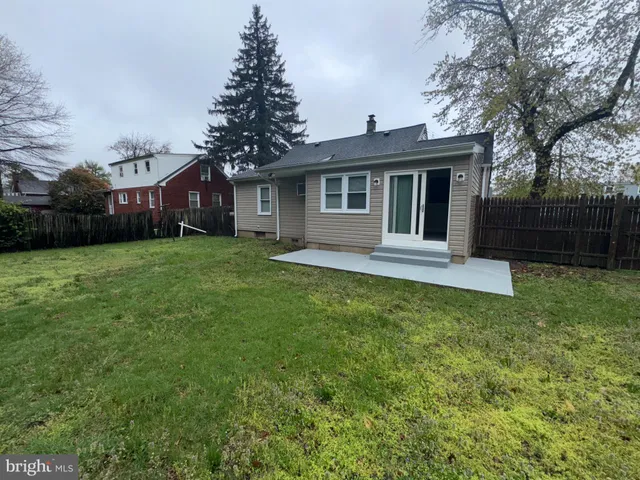 a front view of a house with a garden and yard