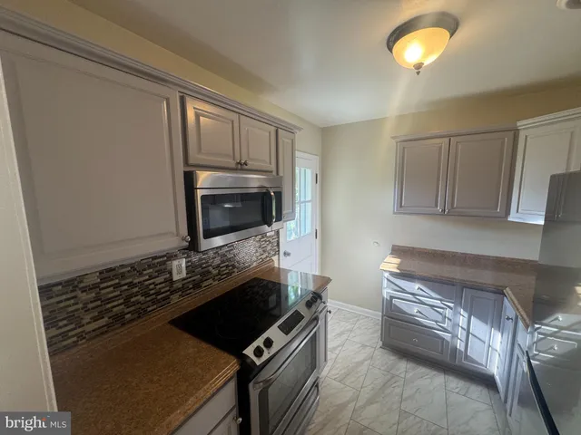 a kitchen with a stove and a microwave