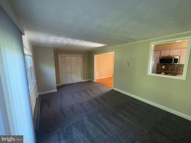 an empty room with wooden floor and closet