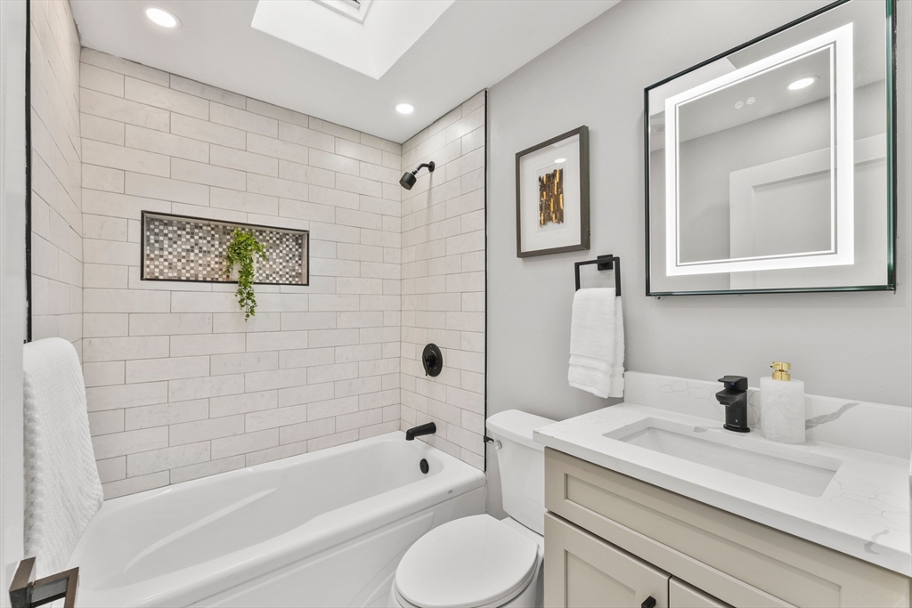 10 Van Brunt Street Boston, MA 02136 - Photo 12 of 31 a bathroom with a sink a toilet and bathtub