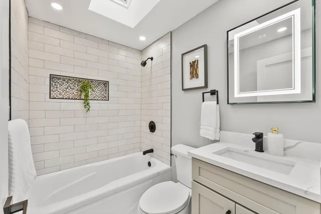 a bathroom with a sink a toilet and bathtub