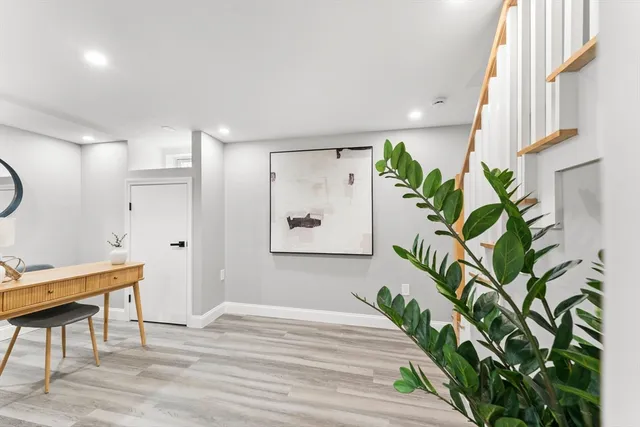 a bedroom with a bed and a potted plant