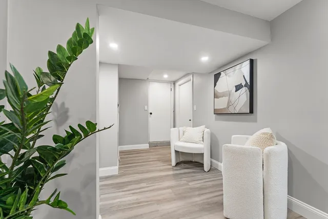 a living room with furniture and a potted plant