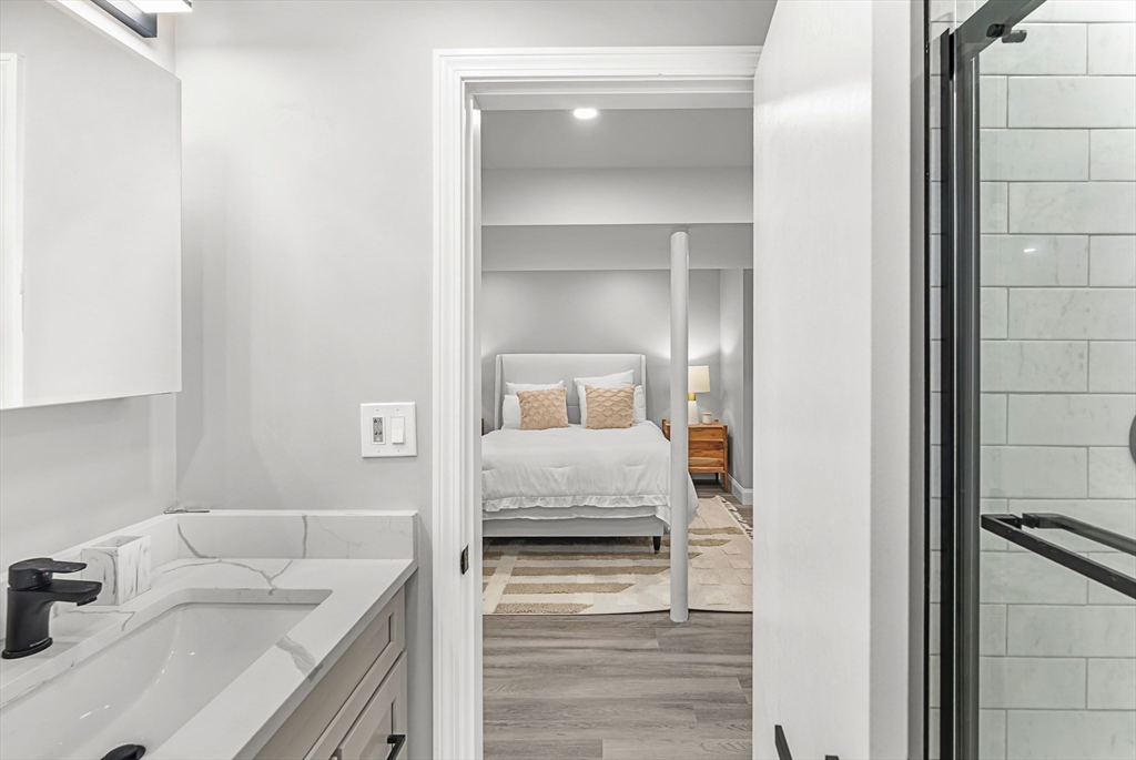 10 Van Brunt Street Boston, MA 02136 - Photo 21 of 31 a bedroom with a bed and a sink