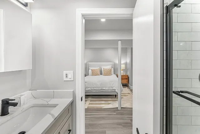 a bedroom with a bed and a sink