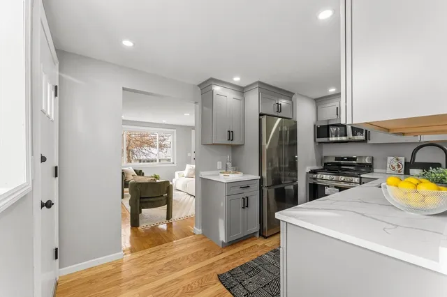 a kitchen with a sink appliances and cabinets