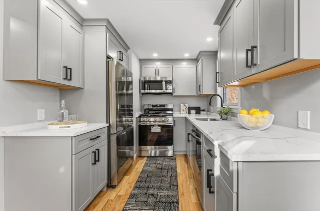 a kitchen with a sink a stove and cabinets