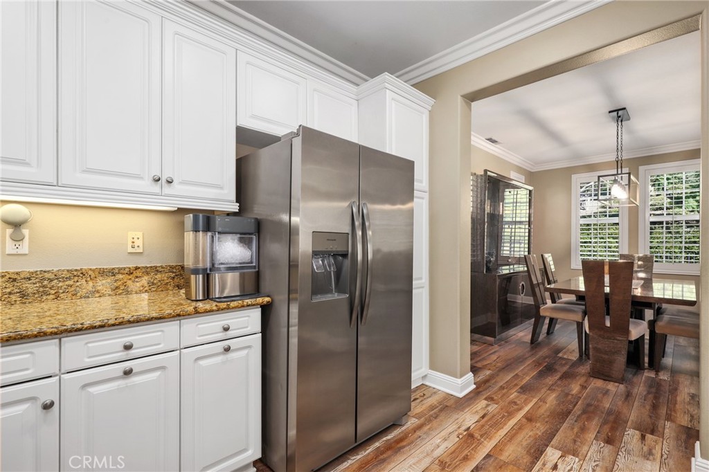 12 Globe Lane Ladera Ranch, CA 92694 - Photo 14 of 37 a kitchen with stainless steel appliances granite countertop a refrigerator sink and cabinets