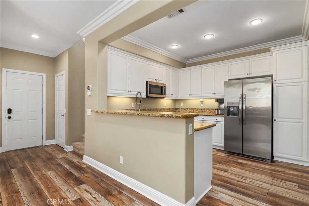 12 Globe Lane Ladera Ranch, CA 92694 - Photo 16 of 37 a kitchen with stainless steel appliances granite countertop a refrigerator and a stove top oven