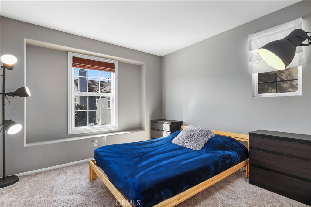 12 Globe Lane Ladera Ranch, CA 92694 - Photo 22 of 37 a bedroom with a bed and a window