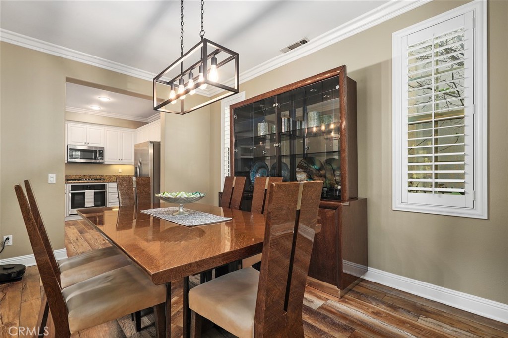 12 Globe Lane Ladera Ranch, CA 92694 - Photo 7 of 37 a view of a dining room with furniture window and wooden floor