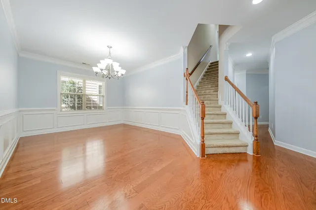 a view of an room with wooden floor and staircase