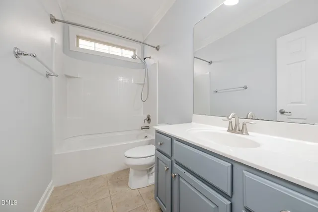 a bathroom with a sink a toilet and a large mirror