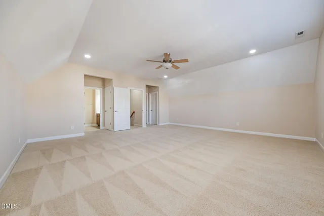 a view of an empty room with a ceiling fan