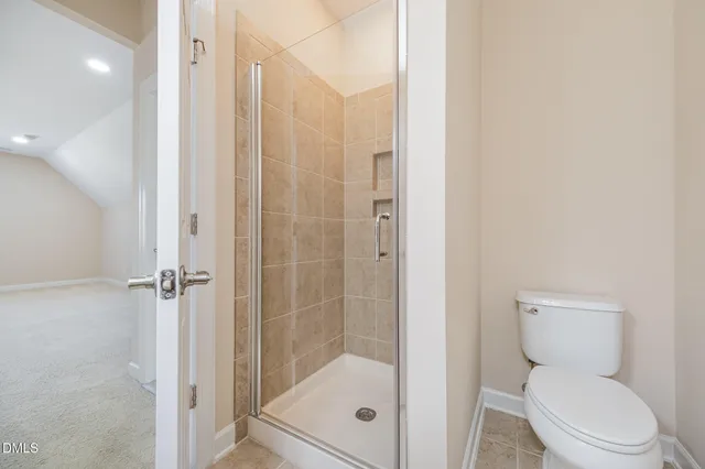 a bathroom with a shower a toilet and a sink