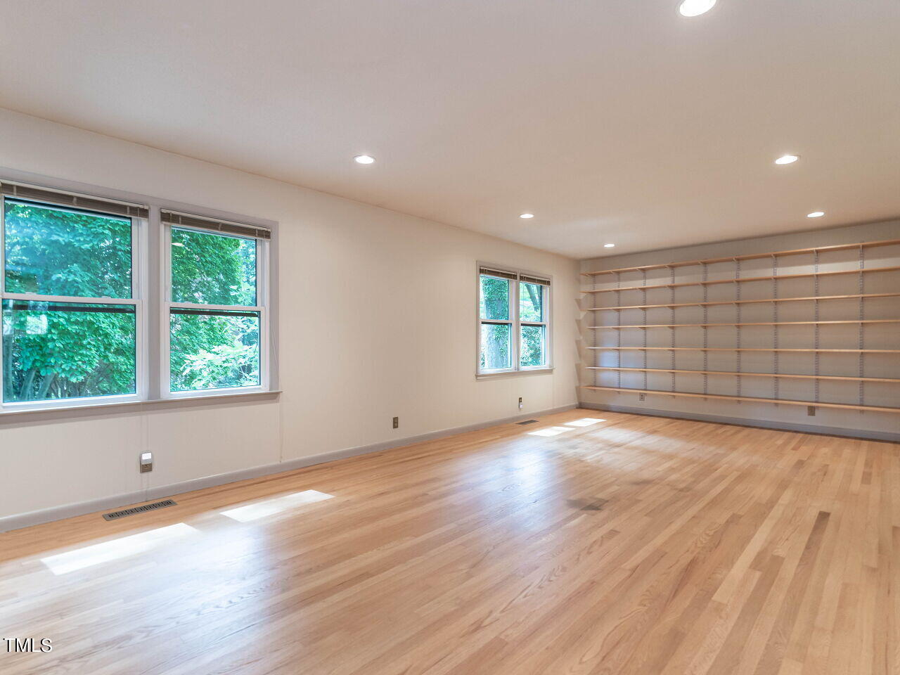 2204 Myron Drive Raleigh, NC 27607 - Photo 14 of 57 The living room has custom adjustable book shelves that "bookend" the room.