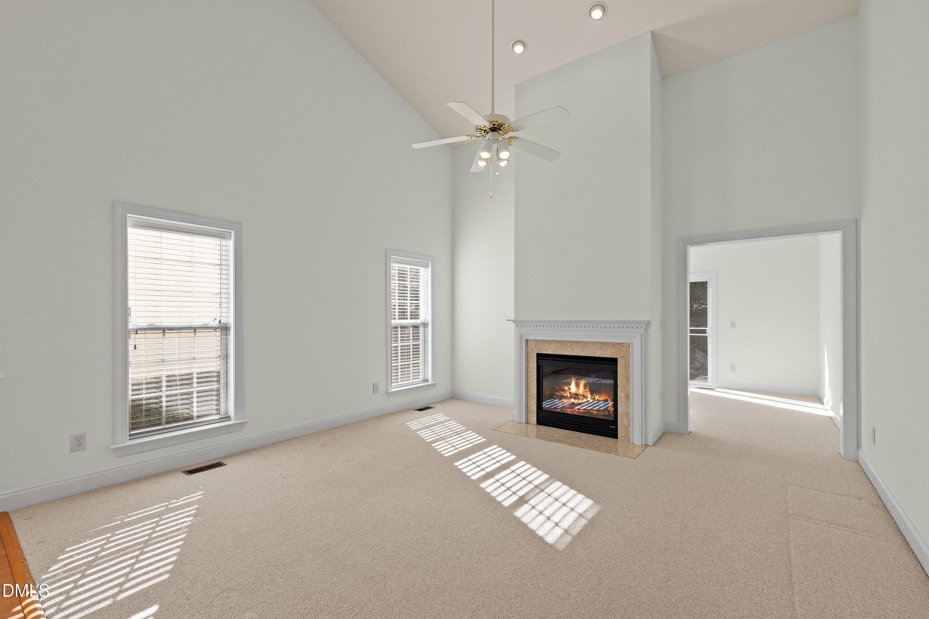 105 Rockport Ridge Way Cary, NC 27519 - Photo 17 of 43 an empty room with windows and fireplace