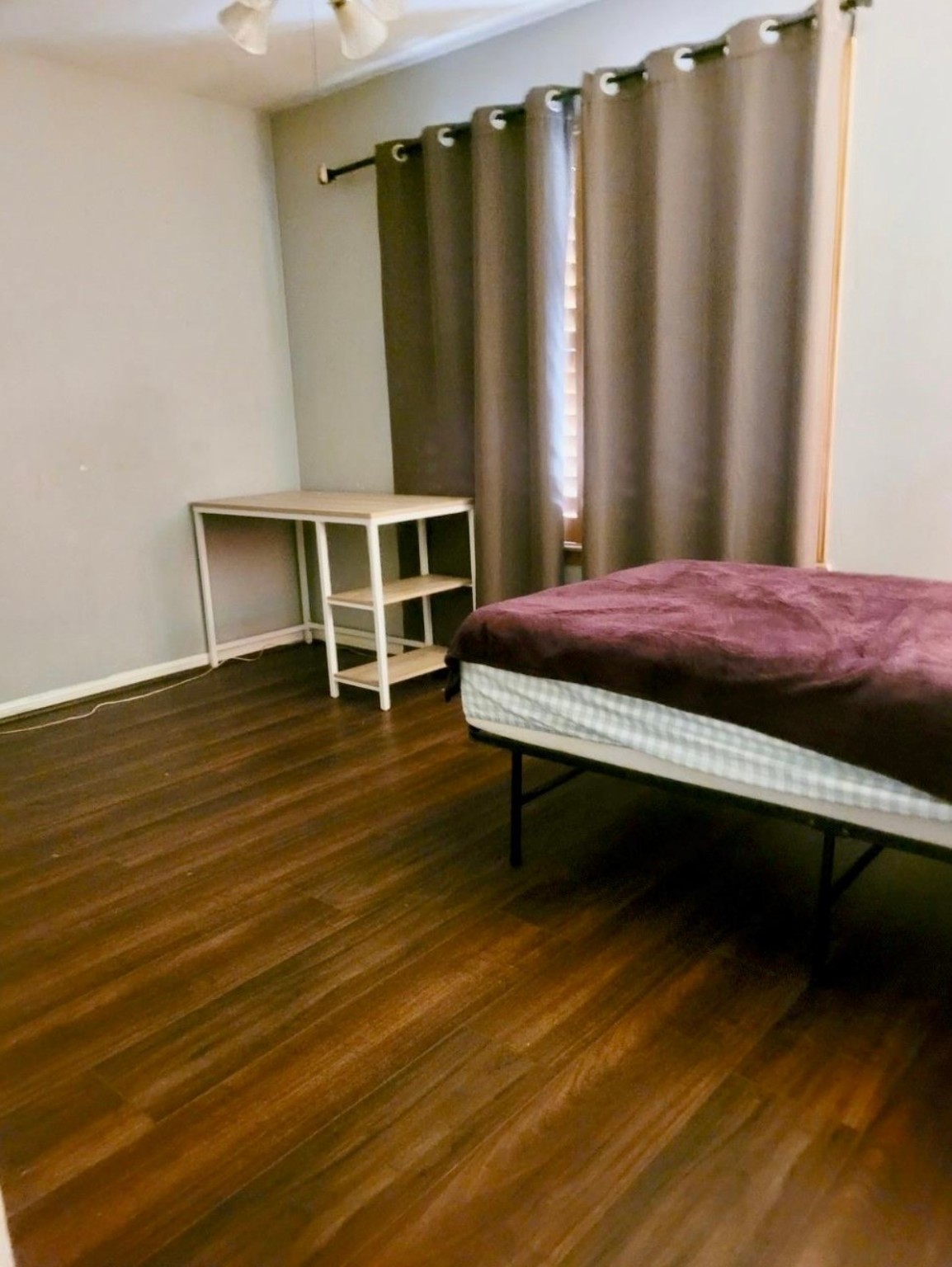 10211 Kerr Lane Conroe, TX 77385 - Photo 20 of 25 a bedroom with a bed and wooden floor