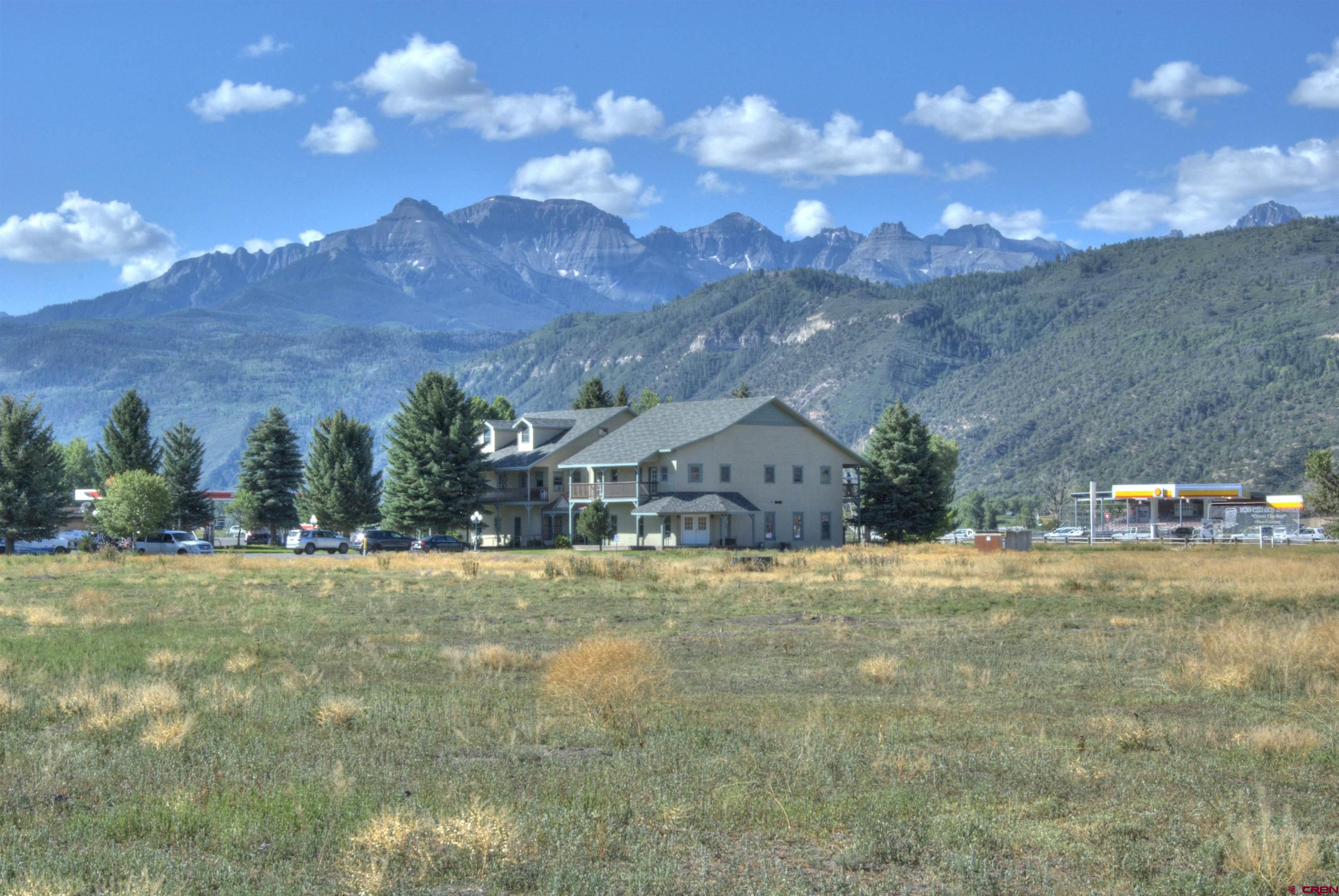 550 Highway 550 Ridgway, CO 81432 - Photo 7 of 9 a front view of a house with a yard and garage