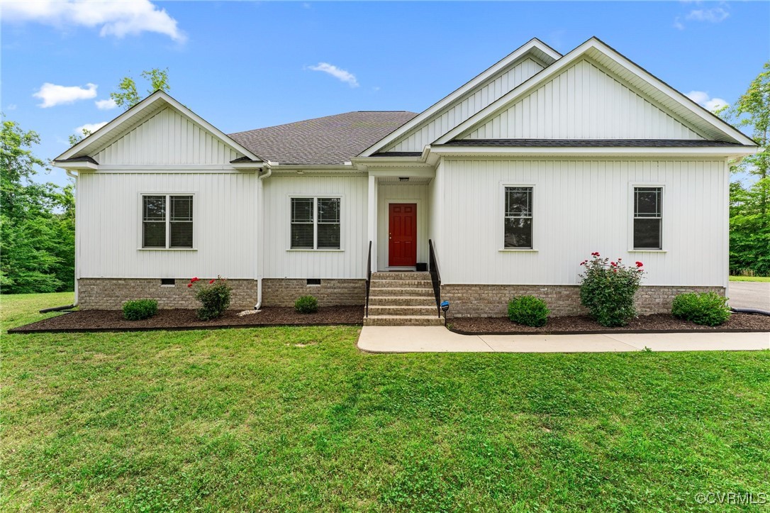 216 Edwin Circle Aylett, VA 23009 - Photo 2 of 27 a front view of a house with a yard and garage