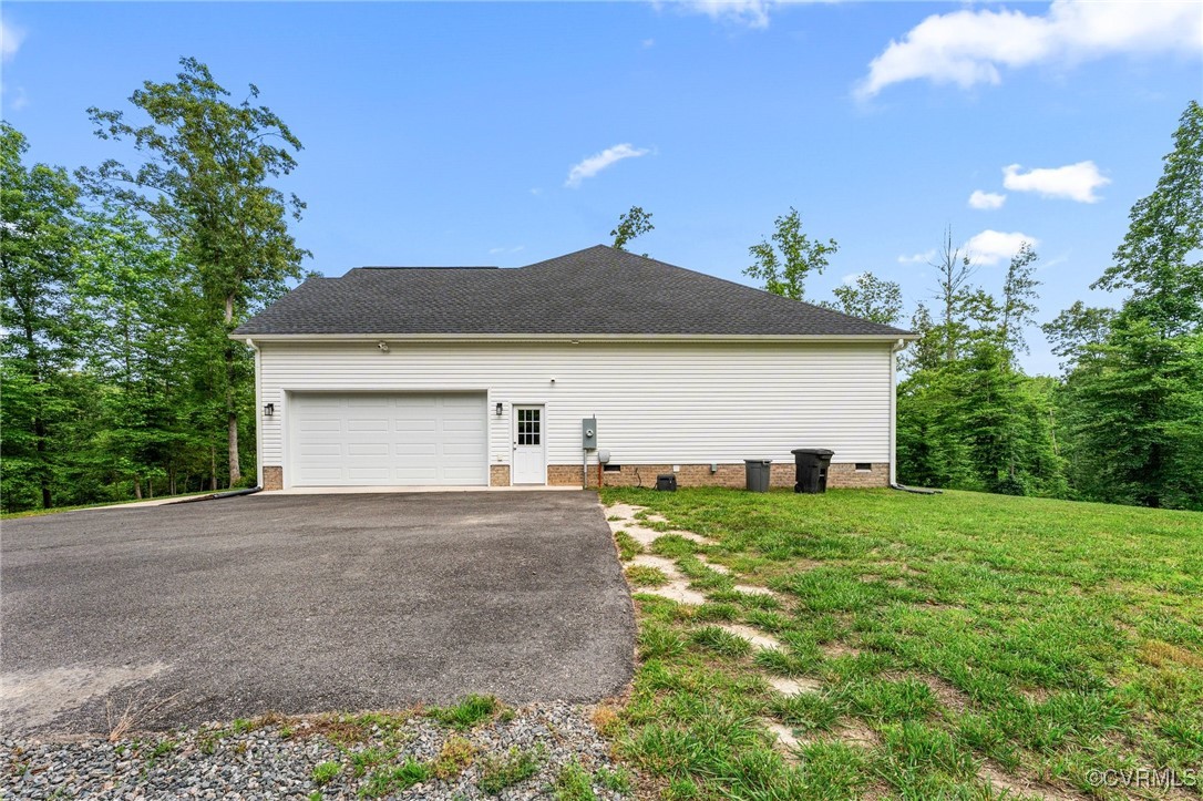 216 Edwin Circle Aylett, VA 23009 - Photo 7 of 27 a front view of a house with a yard and garage