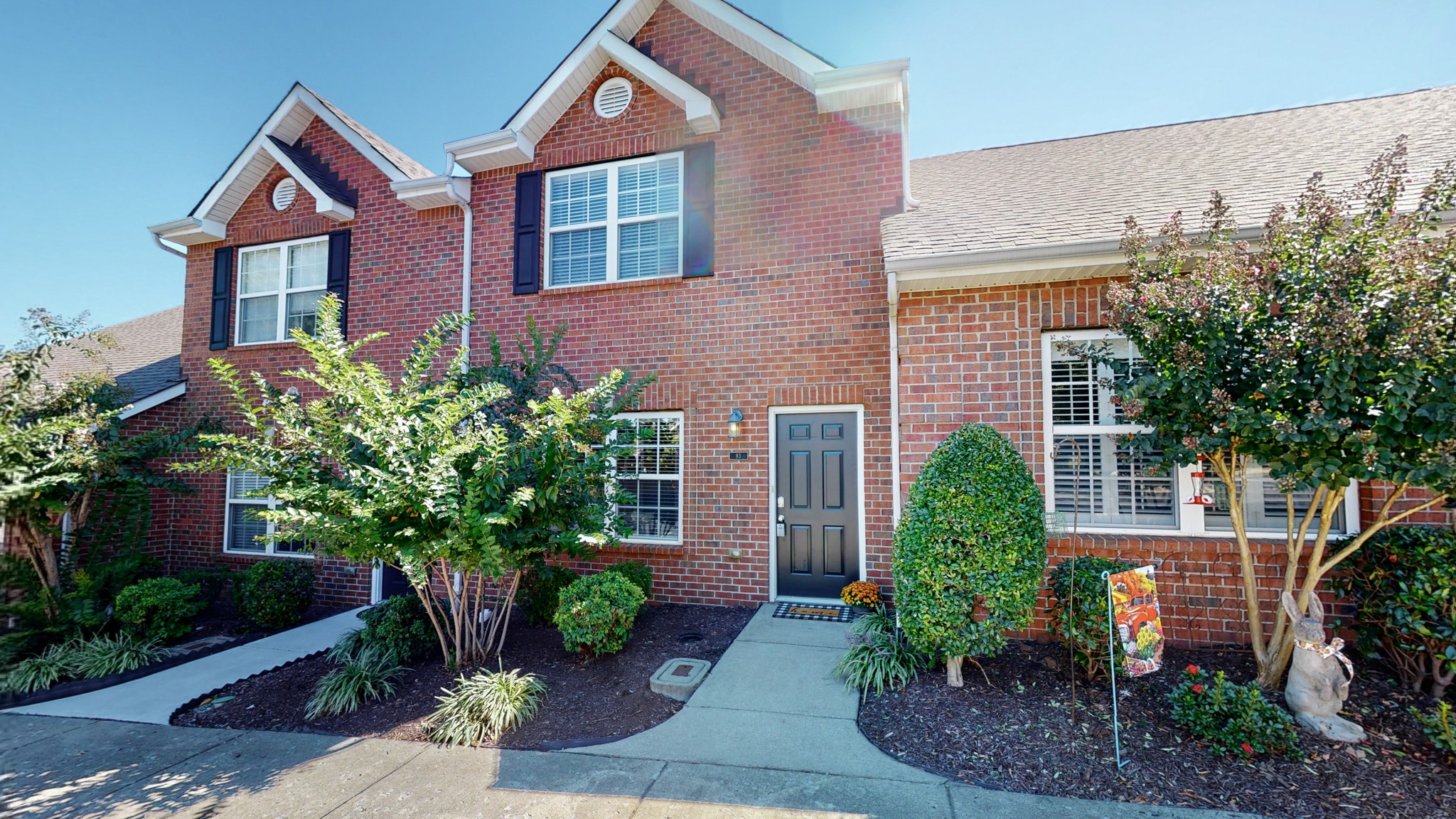 a front view of a house with garden