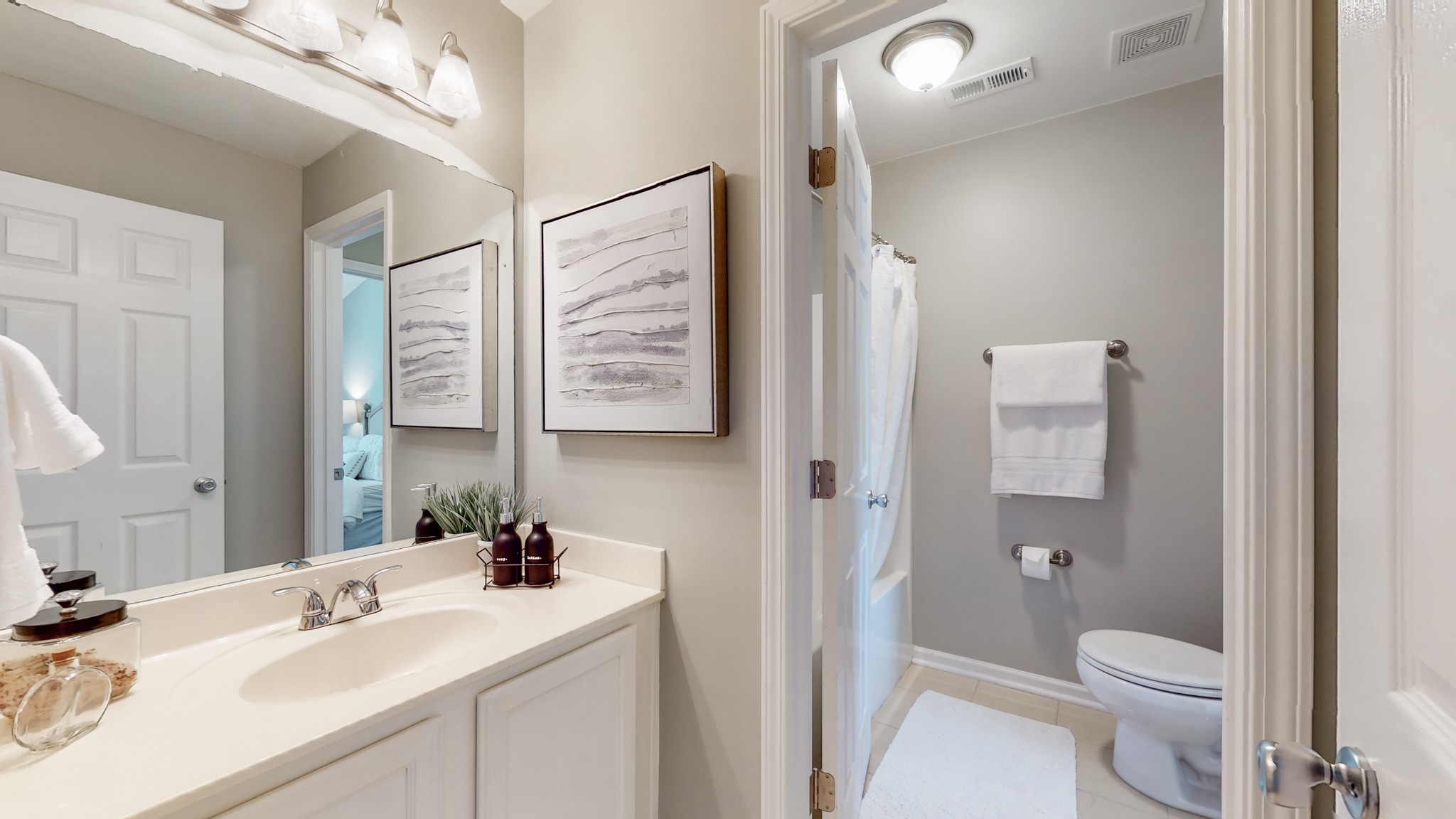 1101 Downs Boulevard, Unit 93 Franklin, TN 37064 - Photo 23 of 38 a bathroom with a sink a toilet a shower and a mirror