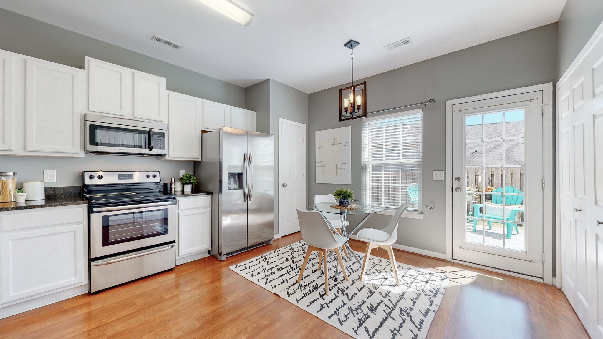1101 Downs Boulevard, Unit 93 Franklin, TN 37064 - Photo 6 of 38 a living room with stainless steel appliances furniture a rug and a kitchen view