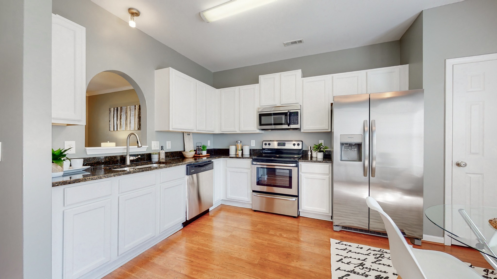 1101 Downs Boulevard, Unit 93 Franklin, TN 37064 - Photo 7 of 38 a kitchen with stainless steel appliances granite countertop a refrigerator a stove and a sink