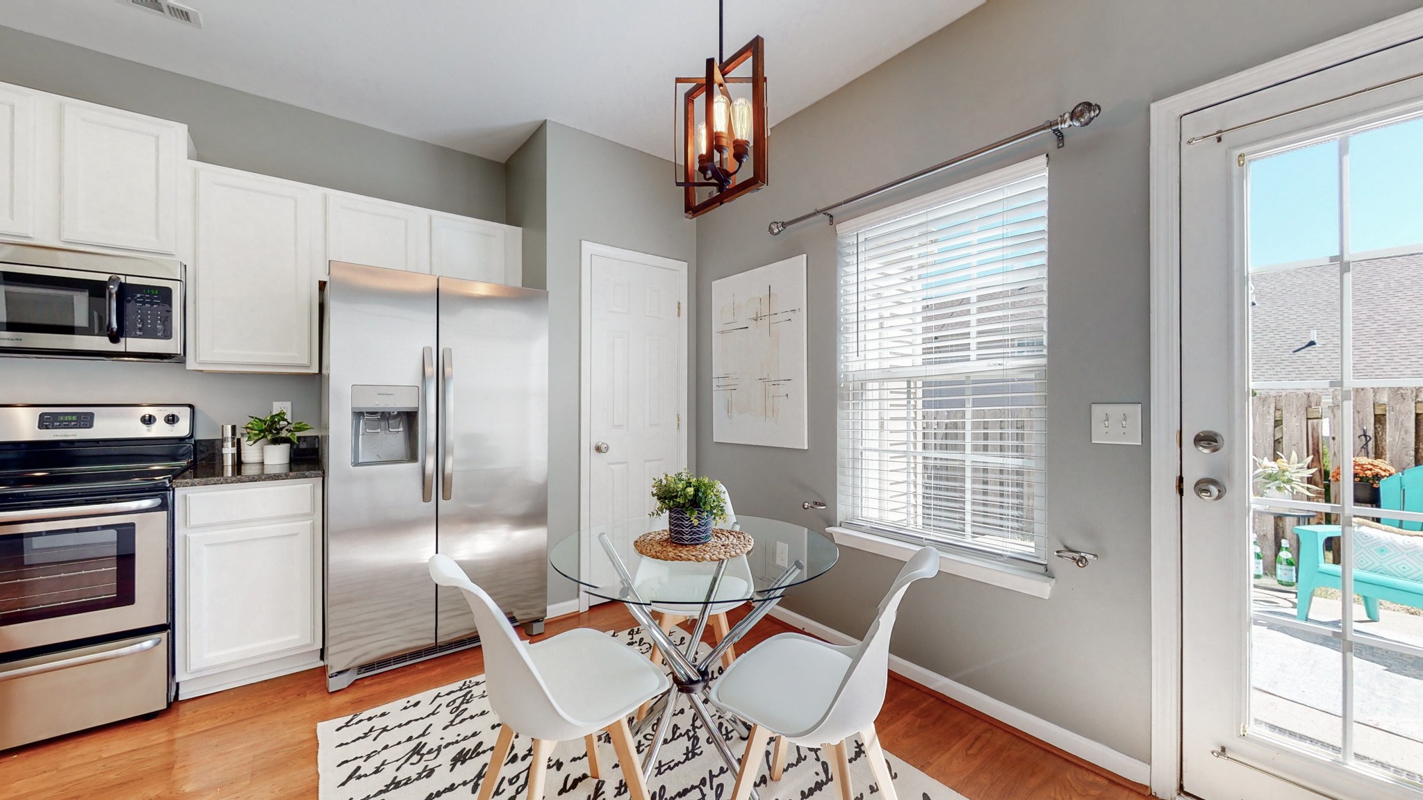 1101 Downs Boulevard, Unit 93 Franklin, TN 37064 - Photo 8 of 38 a kitchen with stainless steel appliances granite countertop a refrigerator a stove a microwave oven a dining table and chairs with wooden floor