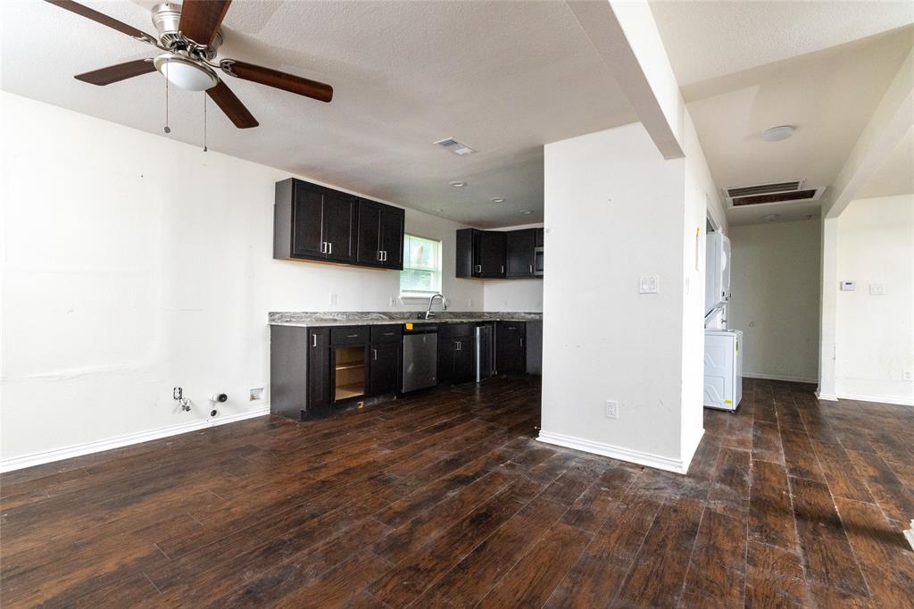 805 East Belt Line Road DeSoto, TX 75115 - Photo 6 of 15 a view of a kitchen with wooden floor and a ceiling fan