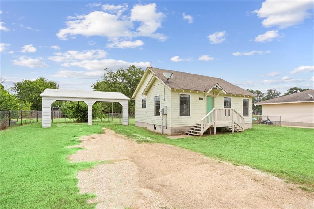 608 9th Street Hico, TX 76457 - Photo 21 of 23 Single-story home featuring a light-colored exterior siding, multi-pane windows, and a covered front entry porch with stairs
