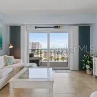 a living room with furniture and a floor to ceiling window