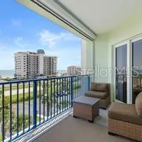 a bed sitting in a spacious bedroom next to a window