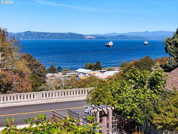 a view of a large body of water with a house in the background