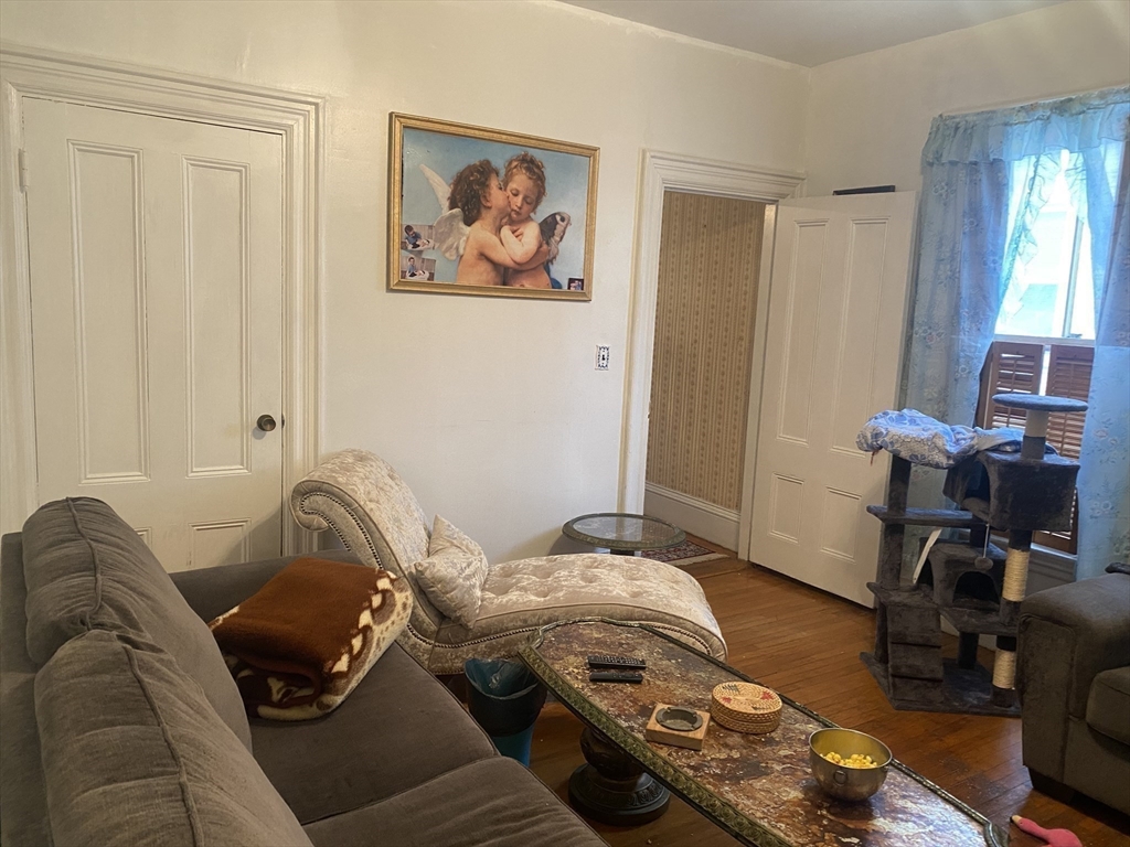 25 West Baltimore Street Lynn, MA 01902 - Photo 6 of 15 a bedroom with a bed and wooden floor
