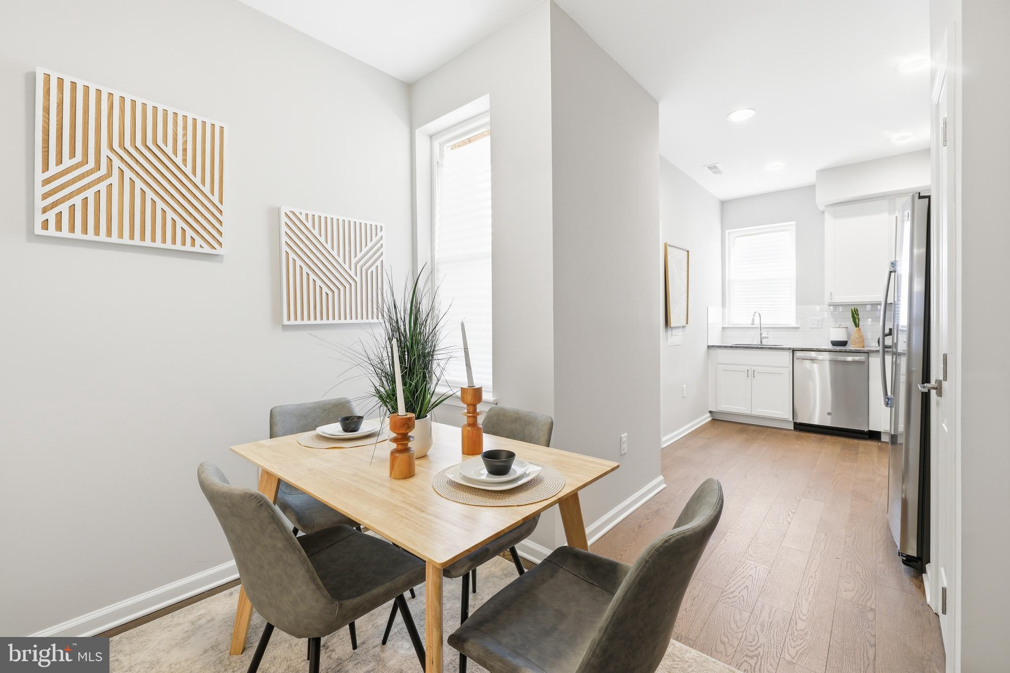 703 East Preston Street Baltimore, MD 21202 - Photo 4 of 26 a view of a dining room with furniture and wooden floor