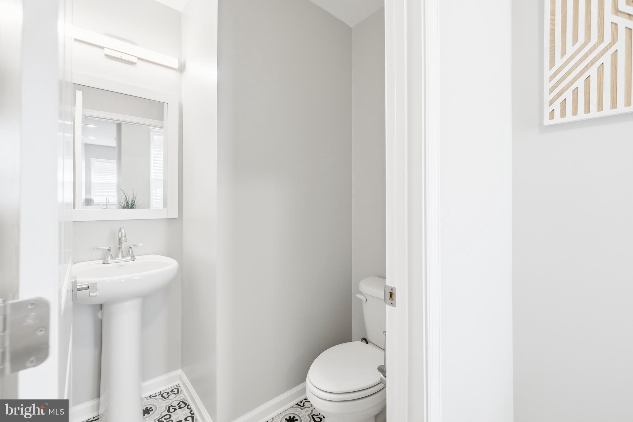 703 East Preston Street Baltimore, MD 21202 - Photo 7 of 26 a bathroom with a toilet sink and mirror