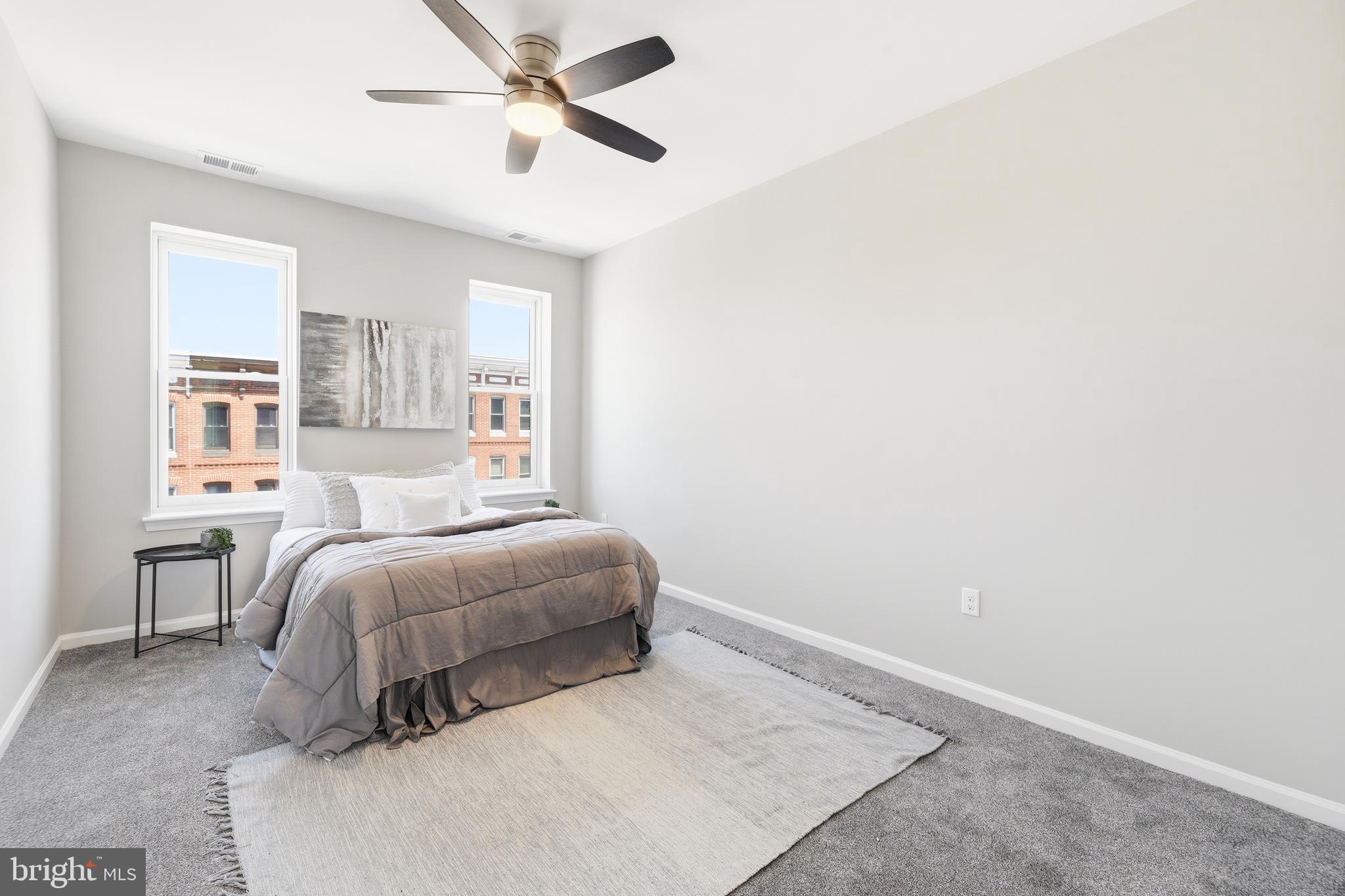 703 East Preston Street Baltimore, MD 21202 - Photo 9 of 26 a bedroom with a bed and a chandelier