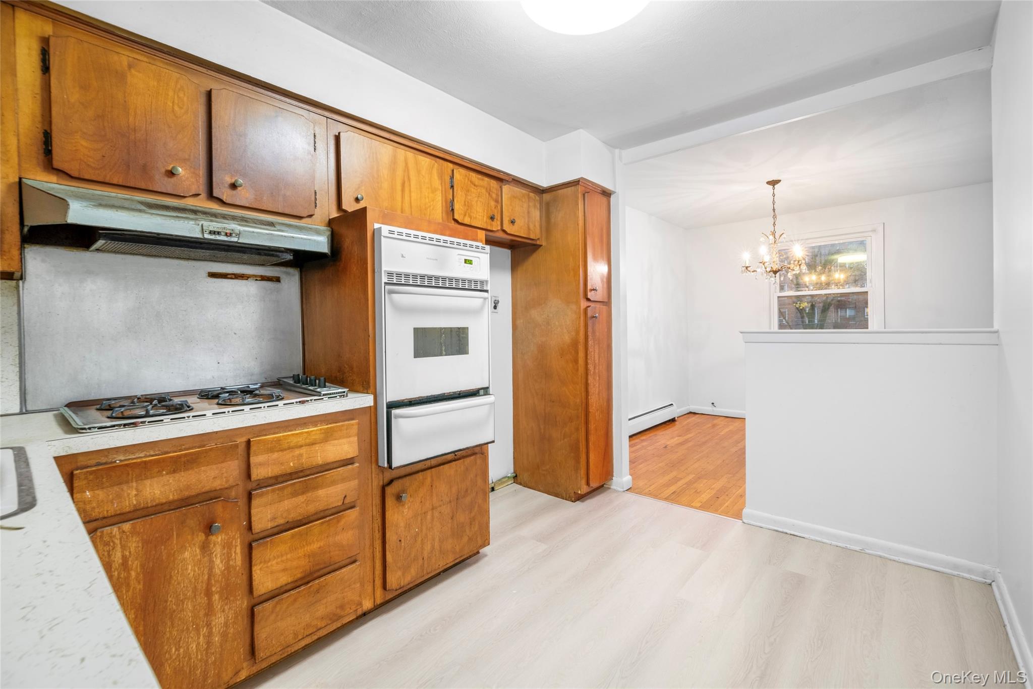 178-59 Wexford Terrace Queens, NY 11432 - Photo 11 of 45 a kitchen with wooden cabinets and a stove top oven
