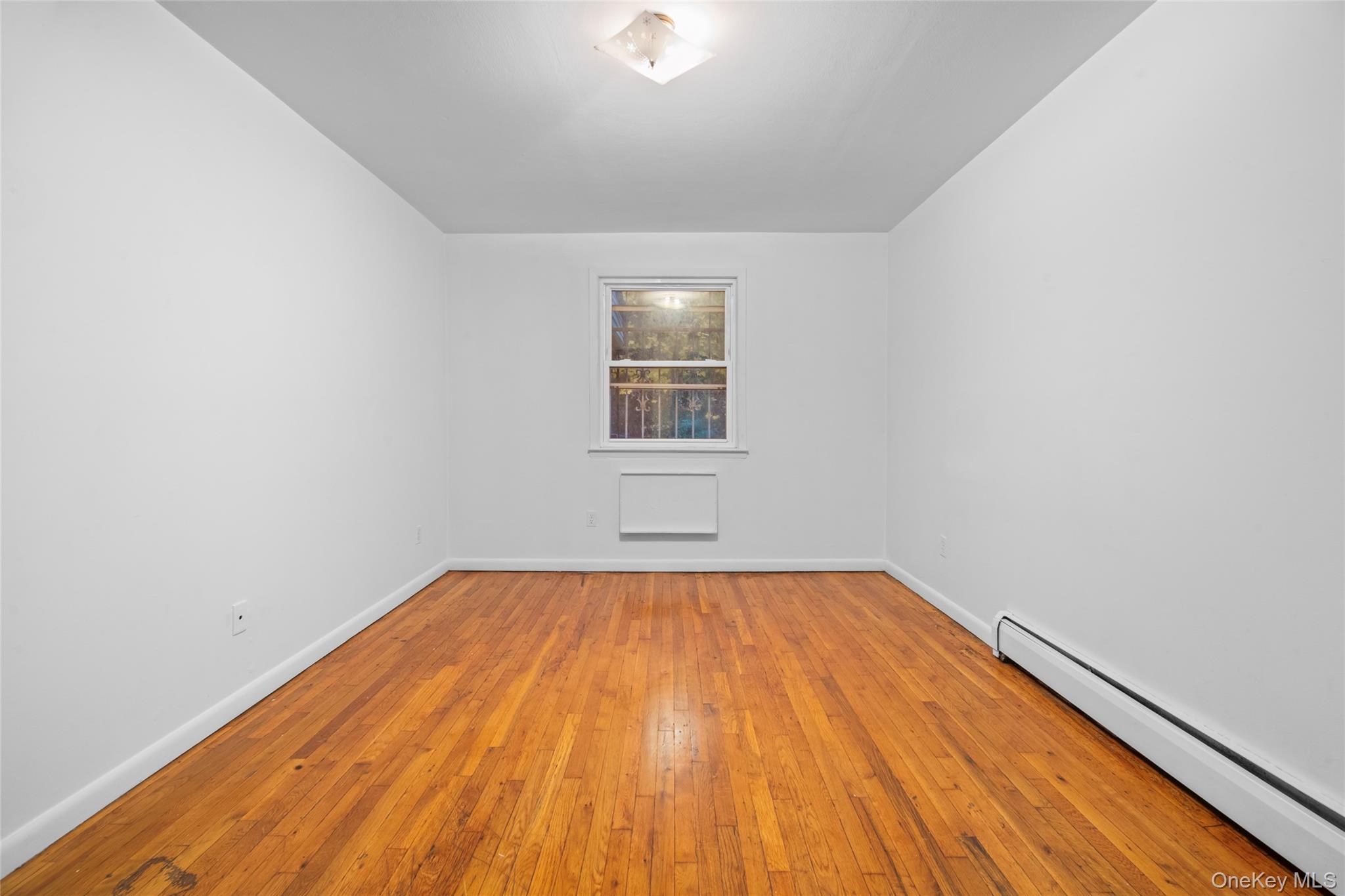 178-59 Wexford Terrace Queens, NY 11432 - Photo 22 of 45 a view of empty room with wooden floor and fan