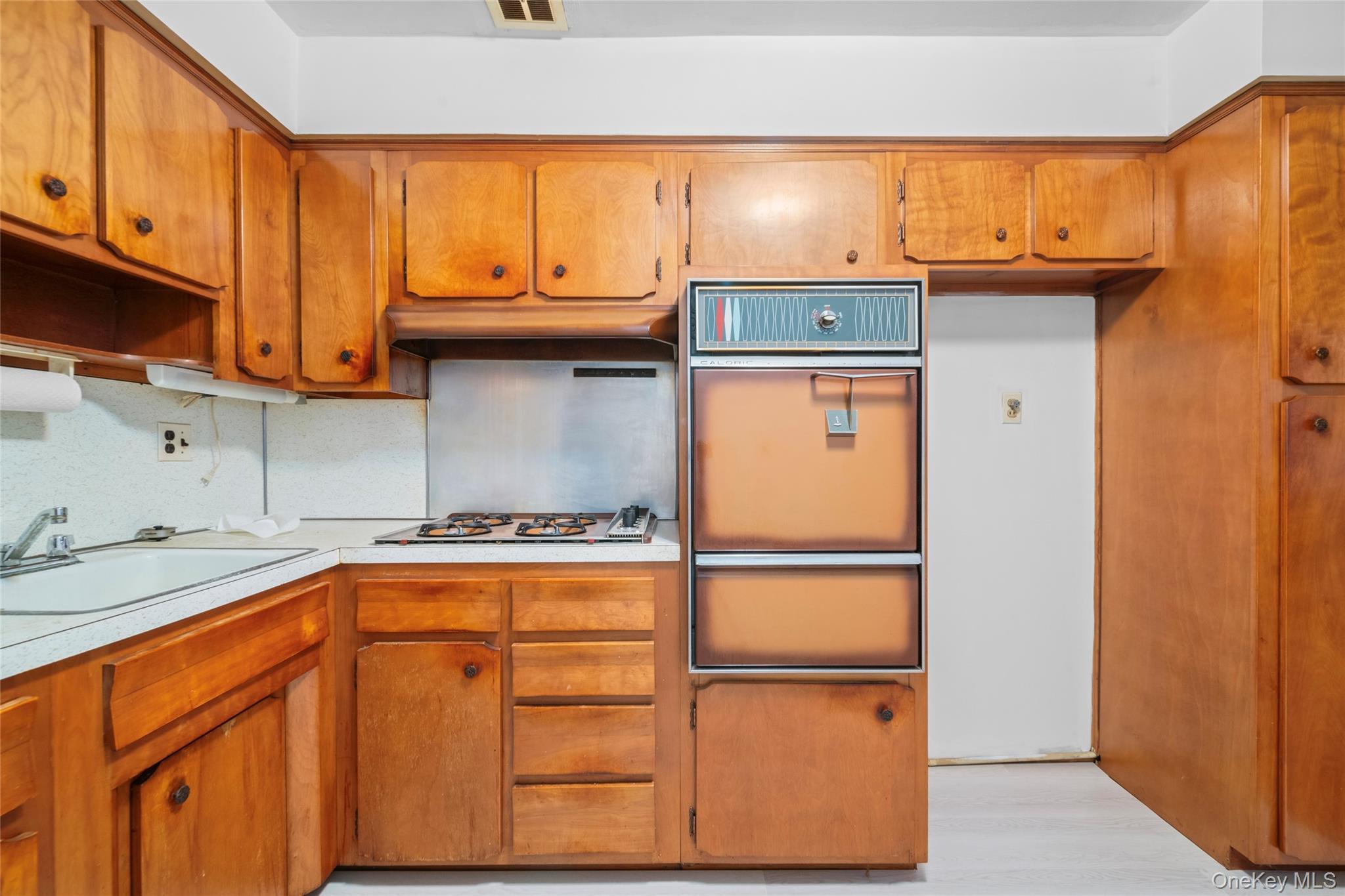178-59 Wexford Terrace Queens, NY 11432 - Photo 35 of 45 a kitchen with a refrigerator and cabinets