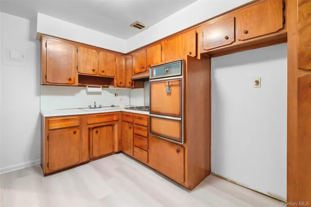 a kitchen with stainless steel appliances granite countertop a refrigerator and cabinets