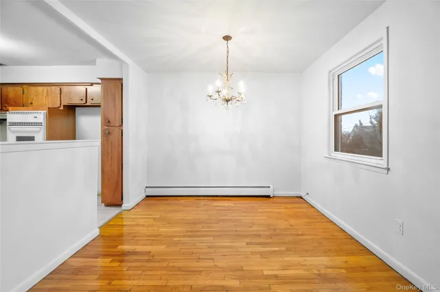 a view of a livingroom with wooden floor and a window